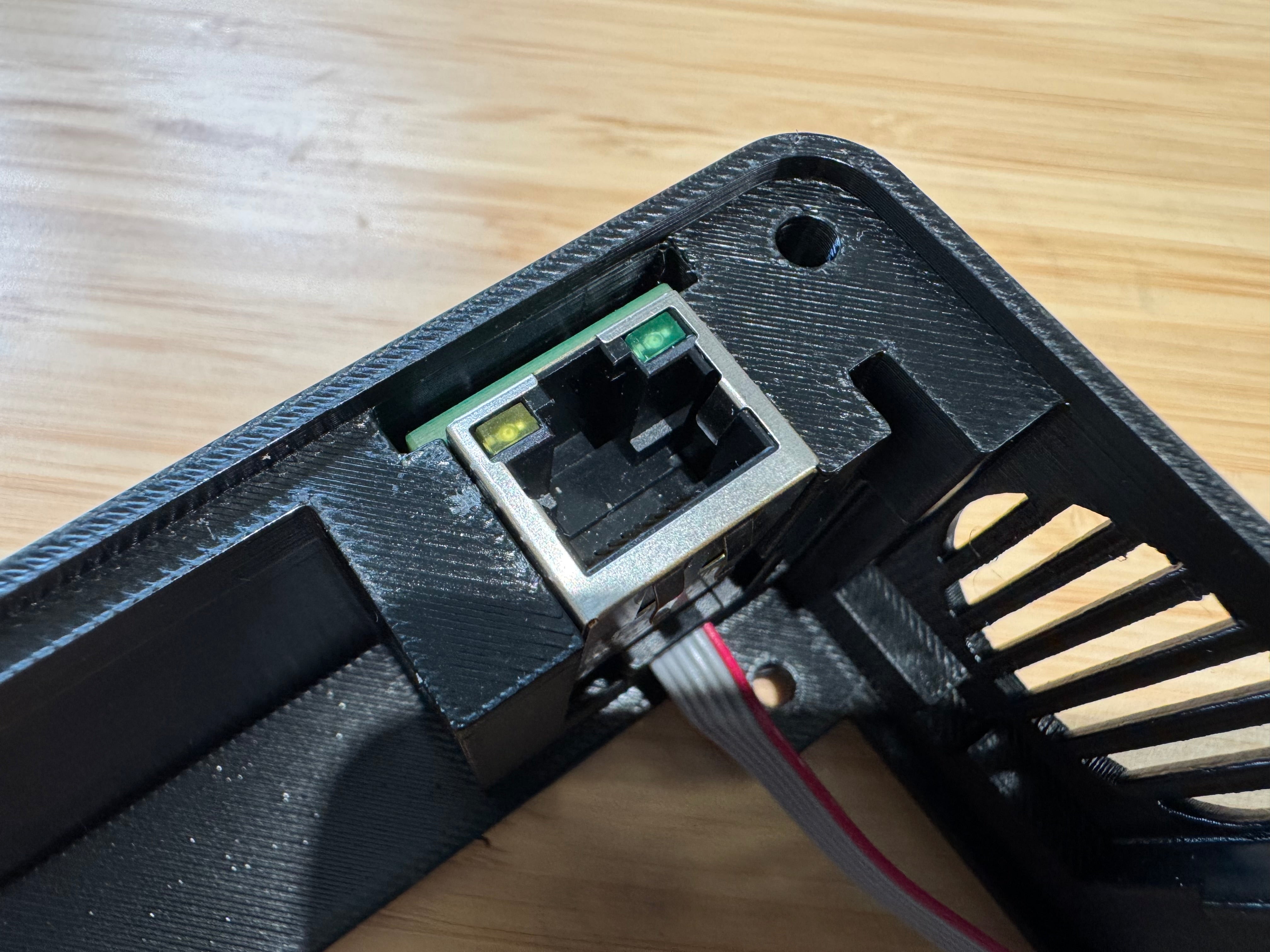 The Ethernet port pressed into its printed mount in the corner of the case, next to the speaker grille