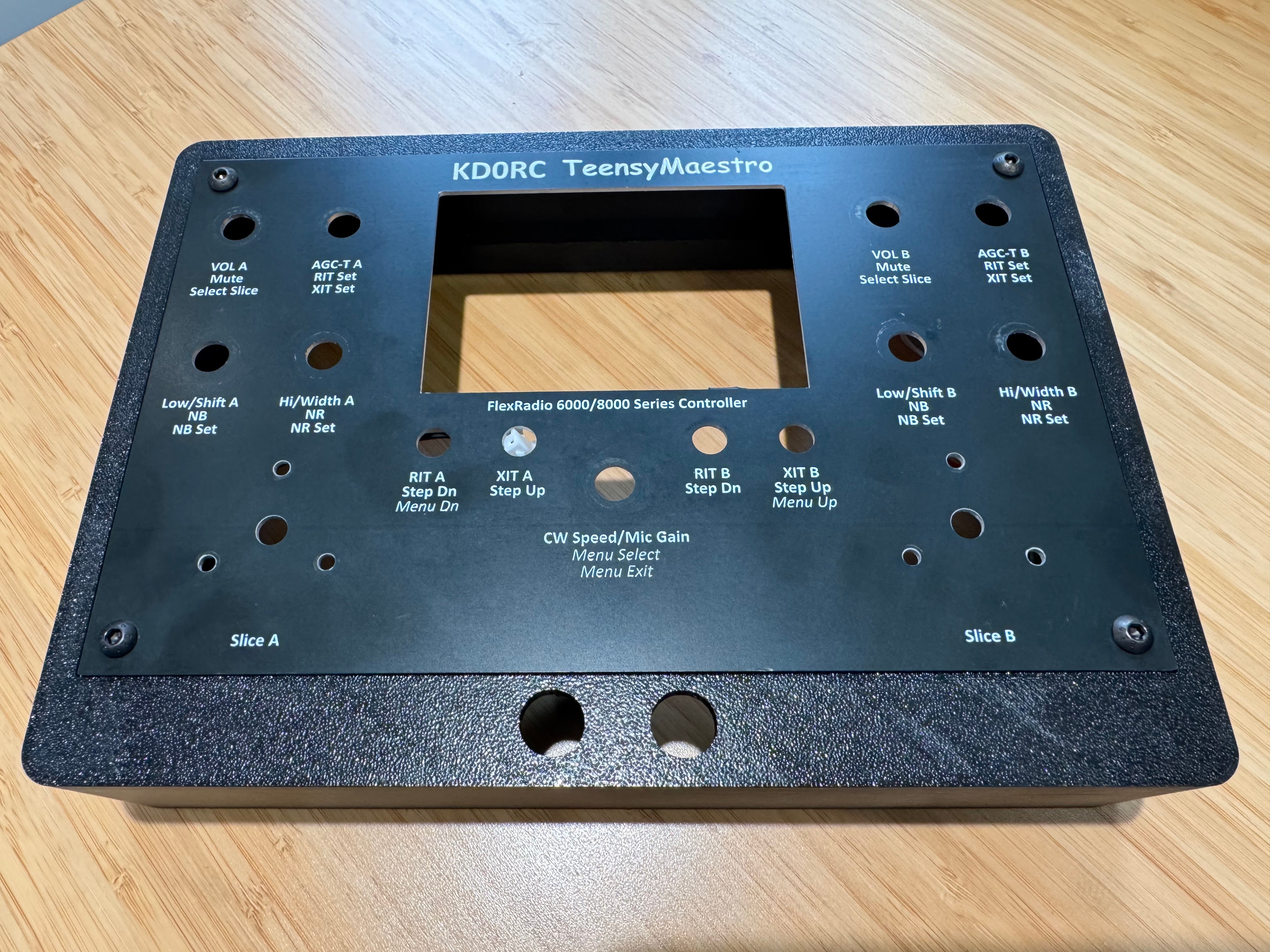 The KD0RC TeensyMaestro front panel sitting in the inset on top of the case, with an M4 bolt in each corner