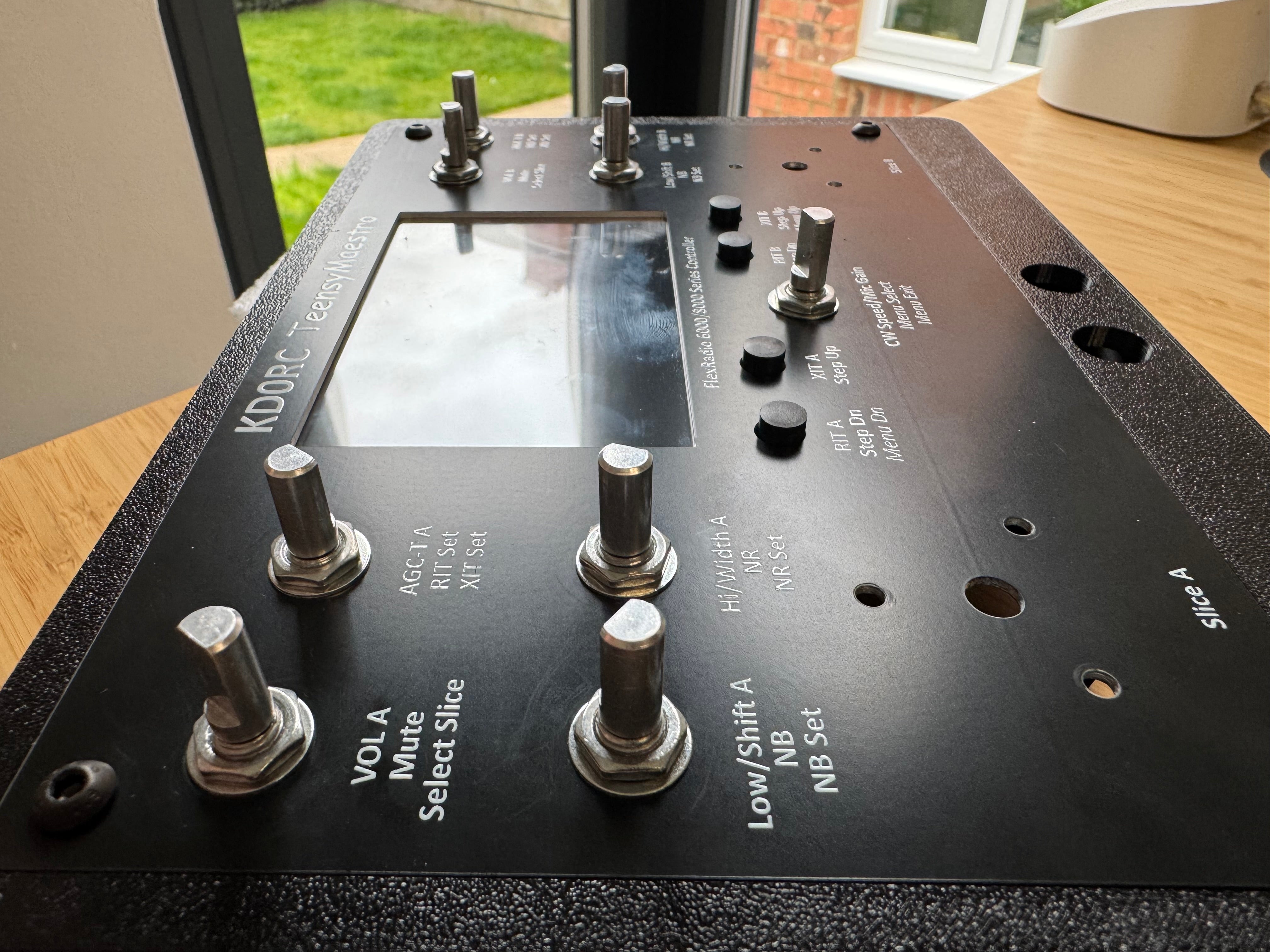 The rotary encoder shafts poking through the front panel, each secured with a washer and nut